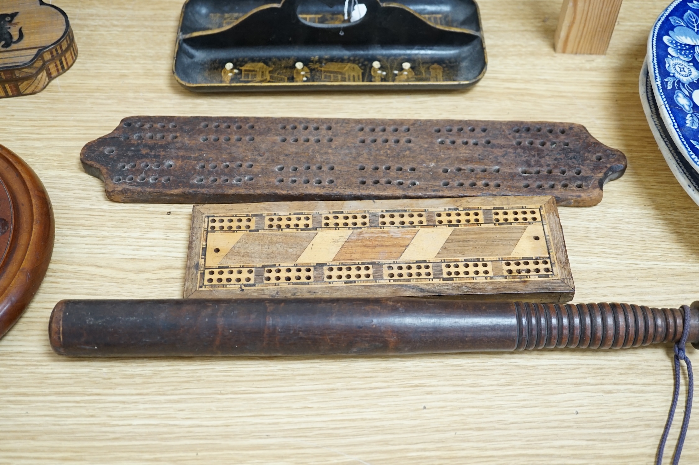 A group of wood items to include two cribbage boards, a mahogany solitaire board with marbles, a truncheon and an inlaid oval tray. etc., largest 60cm wide. Condition - varies, poor to fair